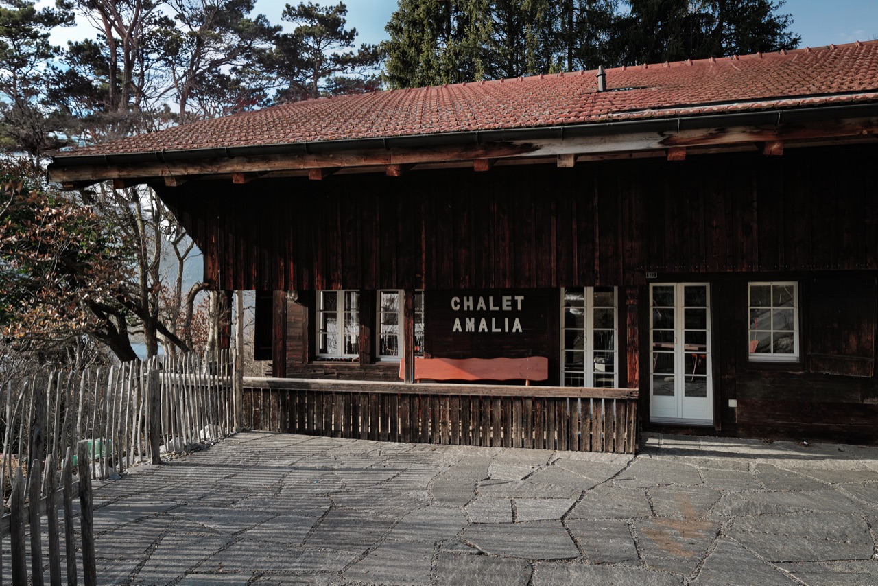 Chalet Amalia entrance with name sign, covered terrace and stone path