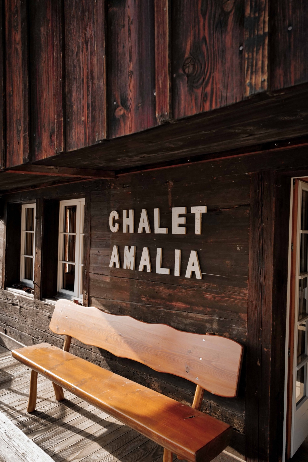 Chalet Amalia name sign with hand-crafted wooden bench on the terrace