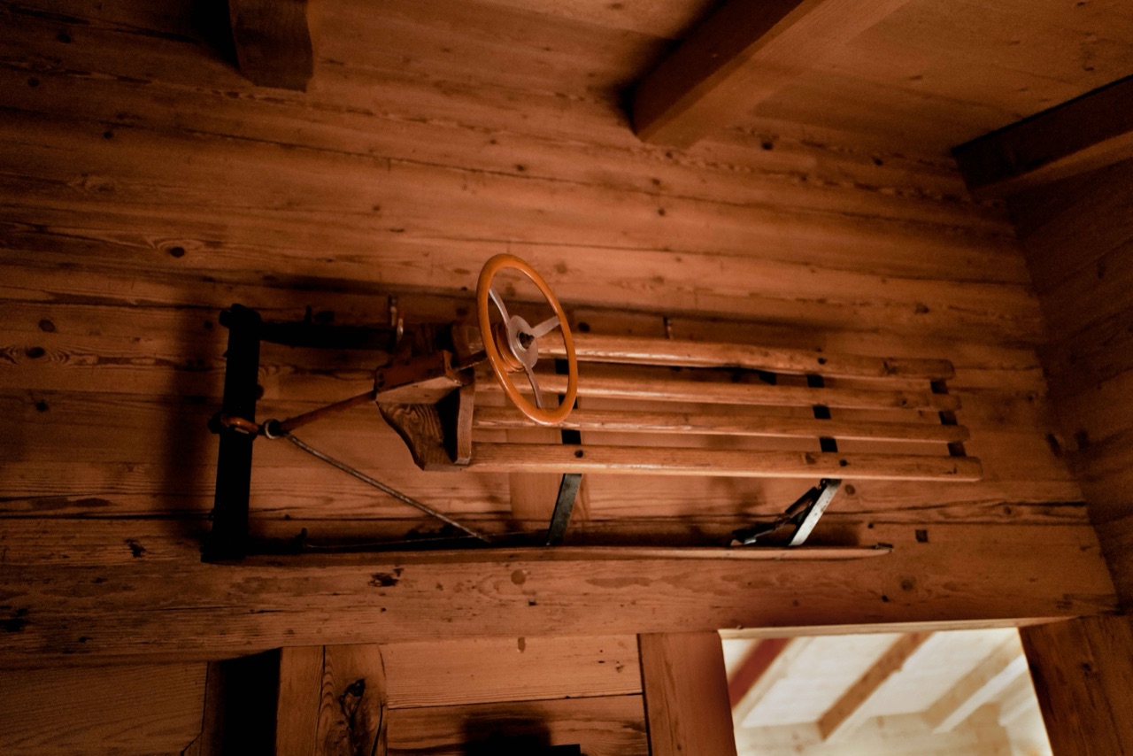 Vintage wooden sled mounted on the timber wall